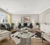 Modern living room with two sofas, armchairs, a cowhide rug, abstract art, and bright yellow curtains.